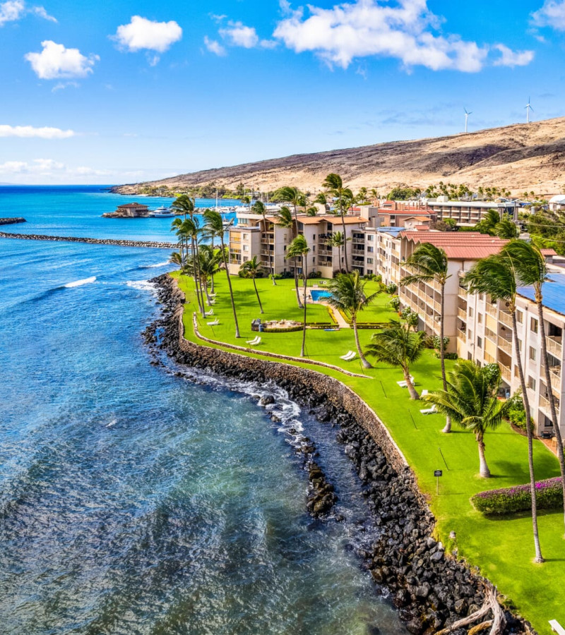 Aerial view of South Maui coastline with oceanfront vacation rentals managed by Hawaii Vacation Homes
